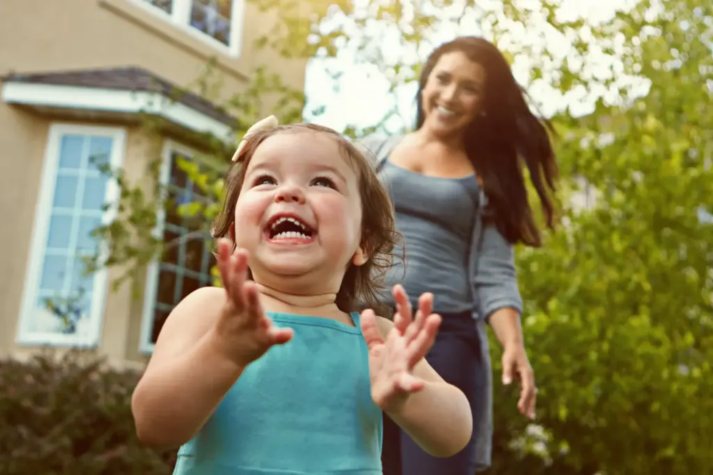 Smiling toddler with parent, representing early childhood dental care