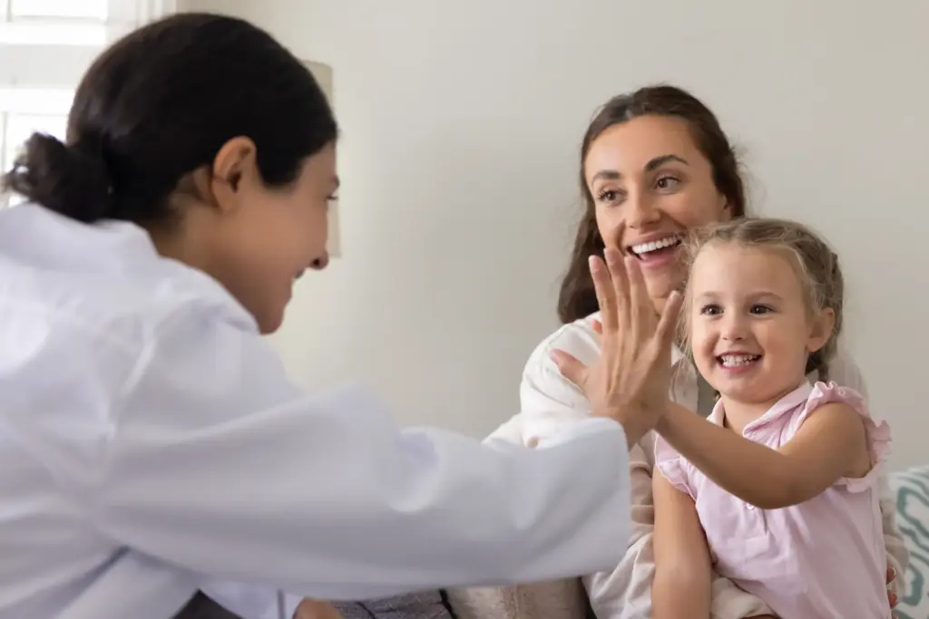 child patient and dentist making high five after a stress-free dental care