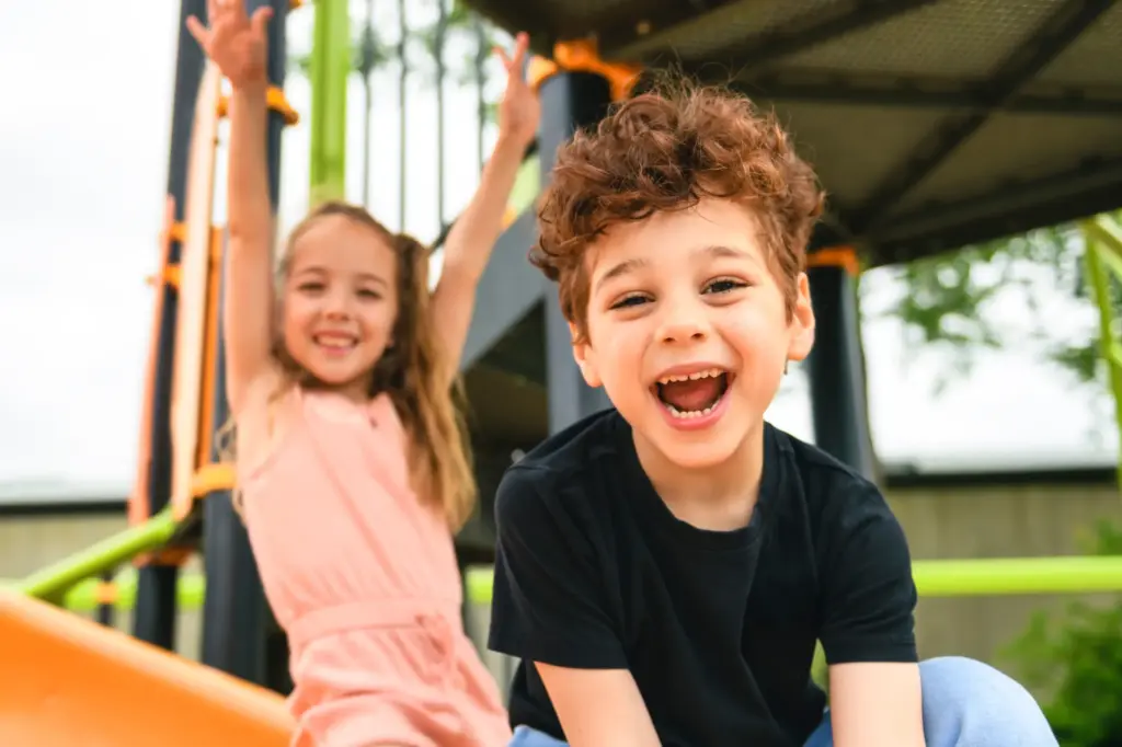 Happy children smiling and playing, representing healthy smiles from pediatric dental care