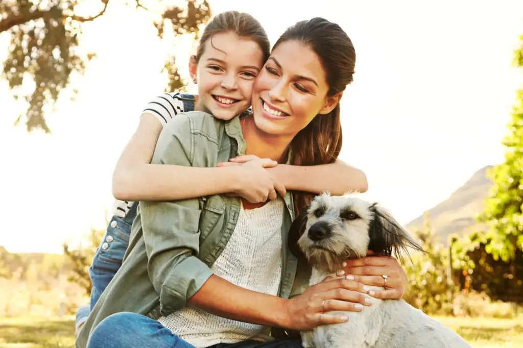 Smiling mother and child with healthy smiles, representing Special needs pediatric dental care